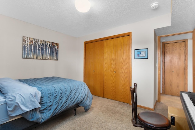 bedroom with a closet, carpet, and a textured ceiling