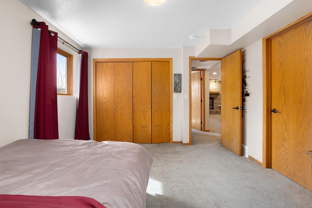 bedroom featuring a closet, baseboards, and carpet