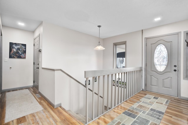 foyer entrance featuring baseboards and wood finished floors