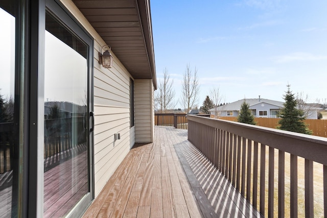 wooden deck featuring a residential view and fence