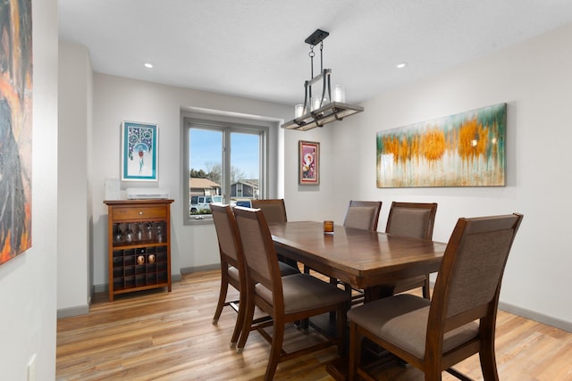 dining room featuring recessed lighting, baseboards, and light wood-style floors