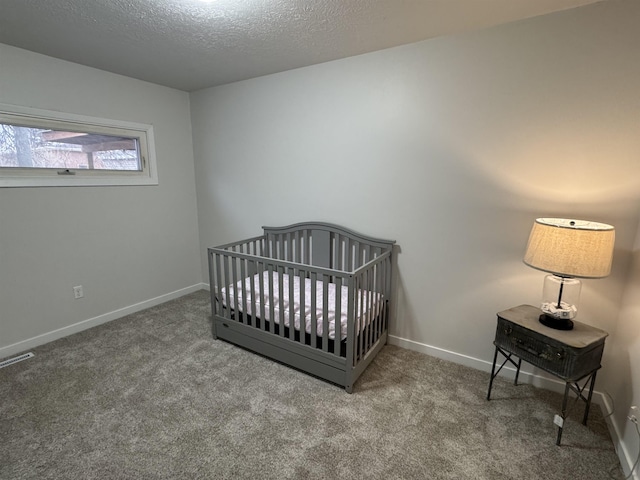 bedroom featuring baseboards, carpet floors, a textured ceiling, and visible vents