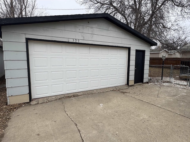 detached garage featuring fence