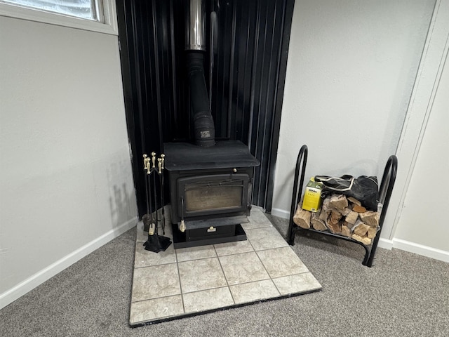 room details with a wood stove, baseboards, and carpet floors