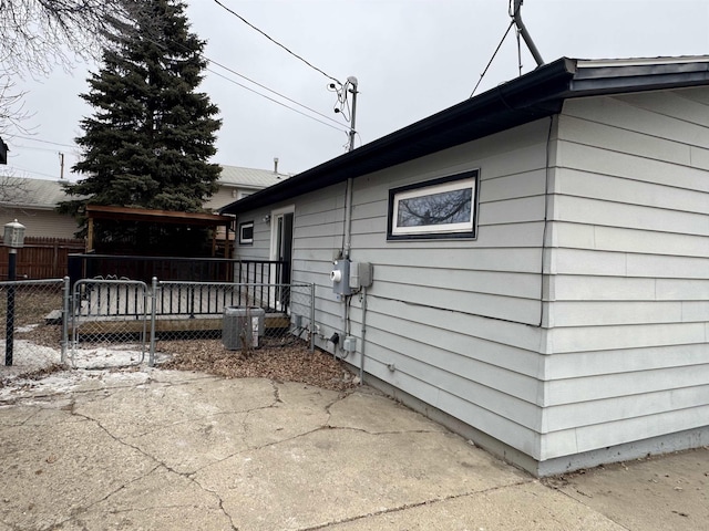 view of side of home with fence