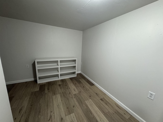 unfurnished room featuring wood finished floors and baseboards