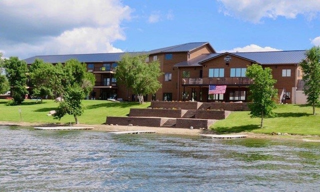 80 Twin Oaks Shr Unit 34, Bottineau, ND 58318 - exterior space featuring a water view, stairway, and a yard