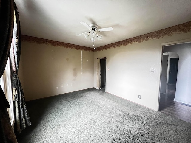 spare room featuring baseboards and ceiling fan