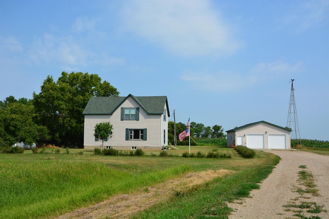 view of front of house with an outdoor structure, driveway, and a garage