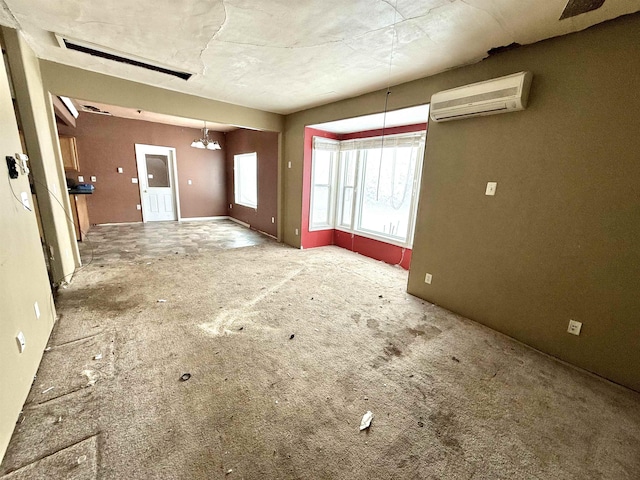 unfurnished living room with a wall mounted AC and visible vents
