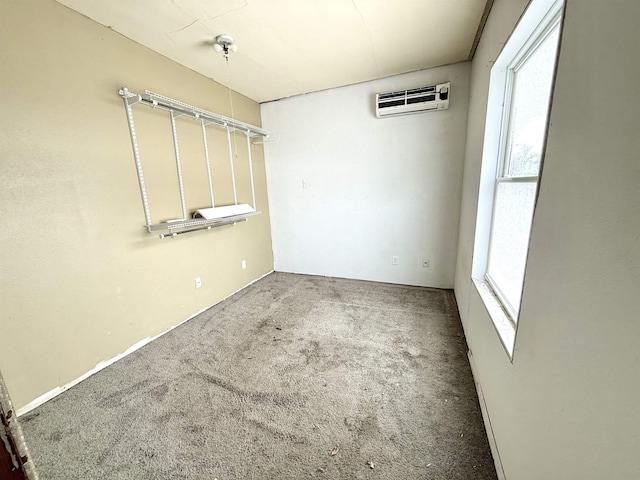 spare room with a wall mounted AC and carpet floors
