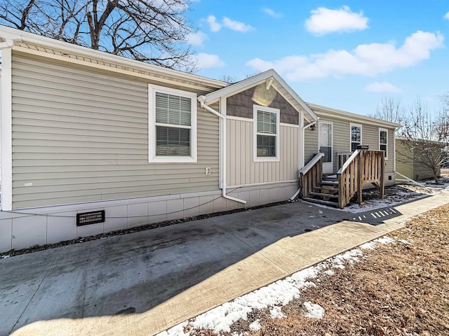 rear view of property with board and batten siding