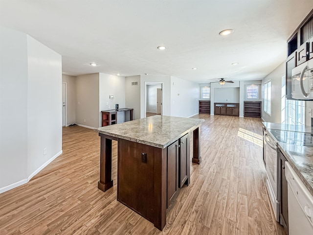 kitchen featuring ceiling fan, dark brown cabinets, light wood-style floors, white microwave, and electric range