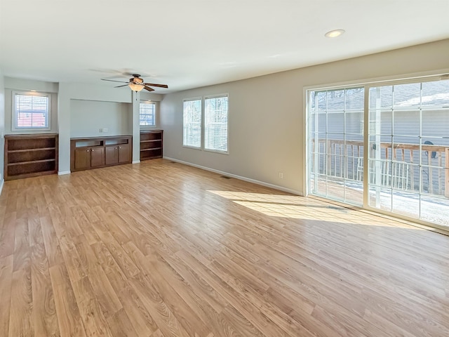 unfurnished living room featuring baseboards, light wood-style flooring, and a ceiling fan