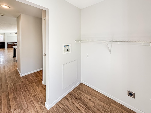 clothes washing area featuring washer hookup, baseboards, wood finished floors, and electric dryer hookup
