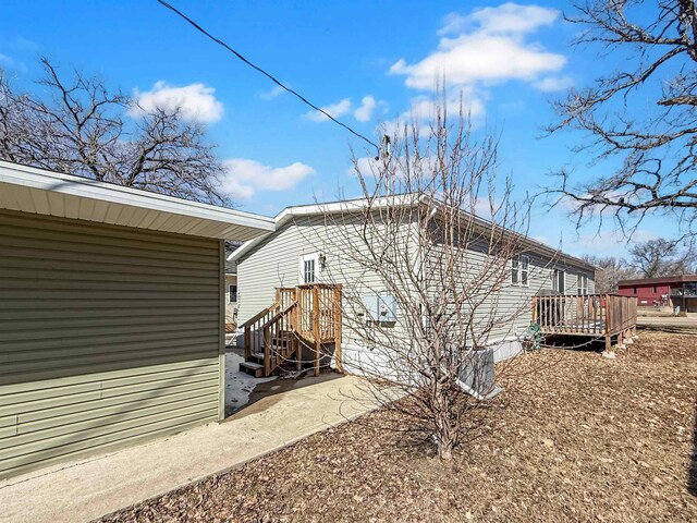 view of side of home featuring a wooden deck