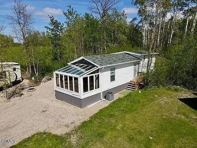 178 Twin Oaks Dr, Bottineau, ND 58318 - view of outdoor structure featuring driveway and cooling unit