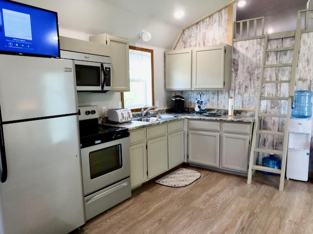 178 Twin Oaks Dr, Bottineau, ND 58318 - kitchen featuring vaulted ceiling, a sink, stainless steel appliances, light wood finished floors, and a toaster