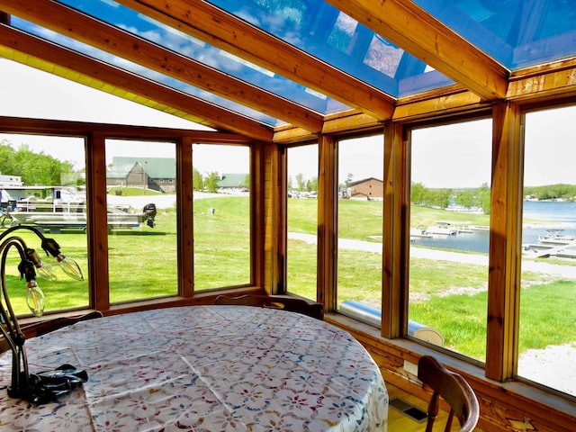 178 Twin Oaks Dr, Bottineau, ND 58318 - unfurnished sunroom featuring a water view, plenty of natural light, and lofted ceiling with beams
