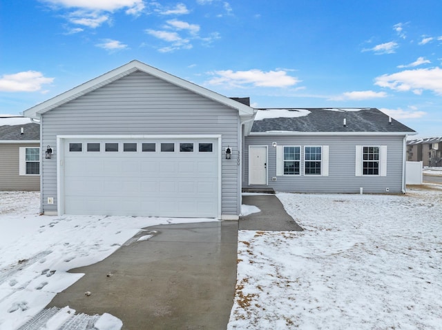 single story home featuring a garage and concrete driveway