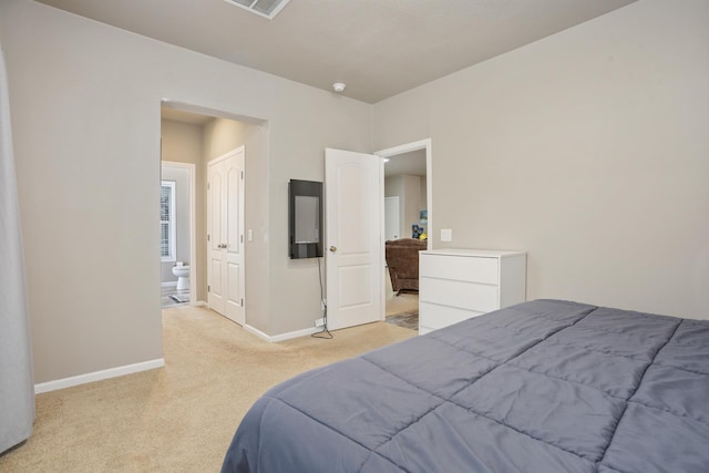 bedroom featuring baseboards and light carpet