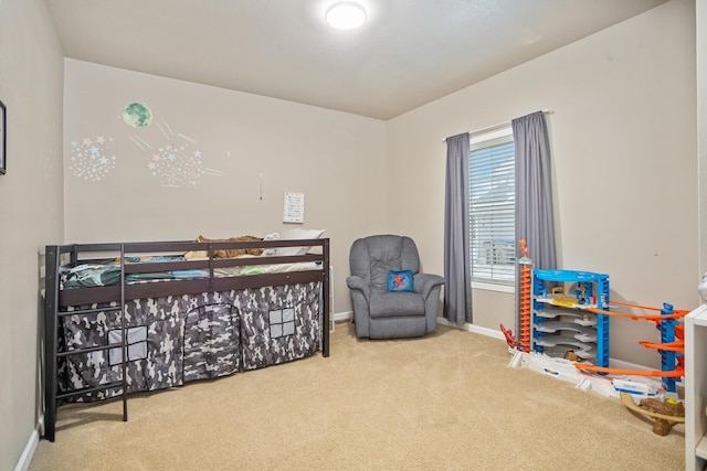 bedroom with baseboards and carpet