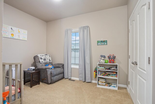 carpeted bedroom featuring visible vents and baseboards