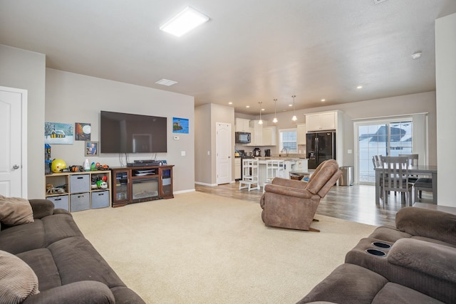 living room with light colored carpet, baseboards, visible vents, and recessed lighting