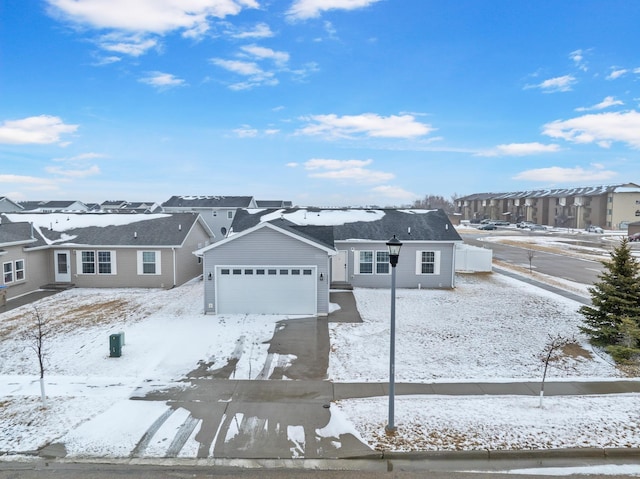 view of front of house featuring driveway, a garage, and a residential view