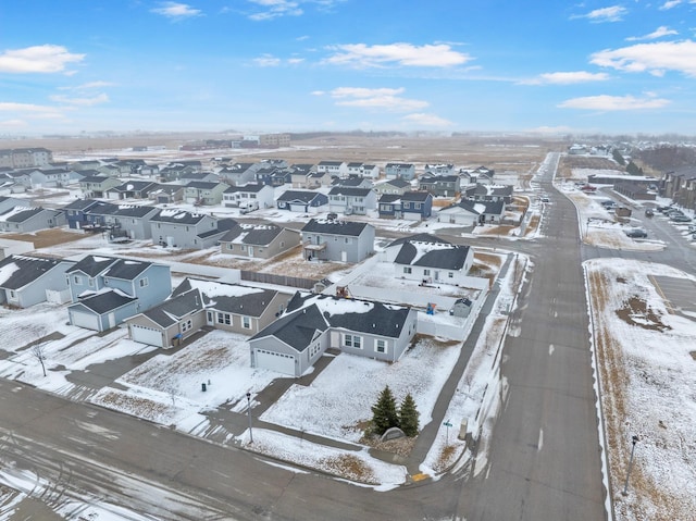 snowy aerial view with a residential view