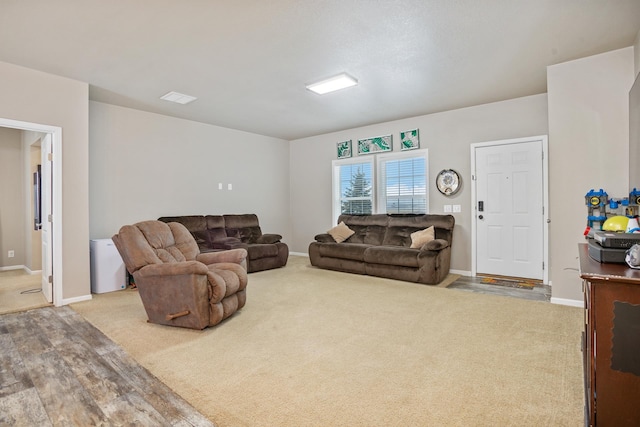 living room with carpet flooring, visible vents, and baseboards