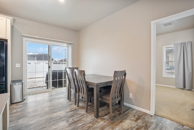 dining area featuring wood finished floors, baseboards, and visible vents