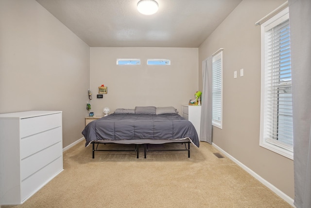 bedroom featuring visible vents, baseboards, and carpet flooring