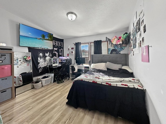 12780 153rd St, Sawyer, ND 58781 - bedroom featuring a textured ceiling and wood finished floors
