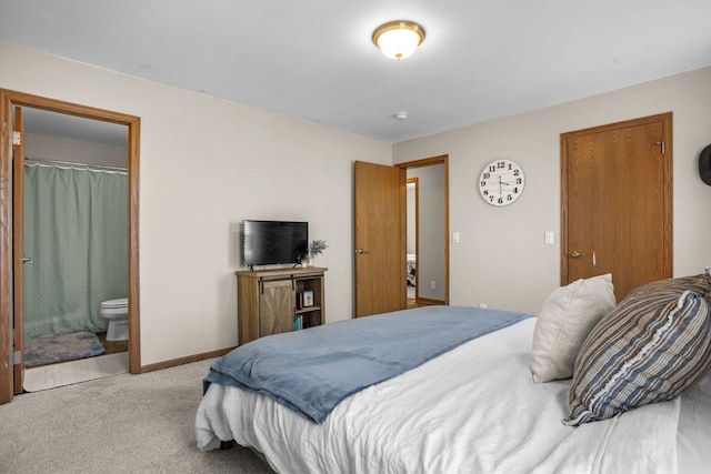 bedroom with baseboards, carpet flooring, and connected bathroom