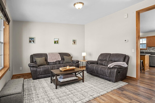living area with dark wood-style floors and baseboards