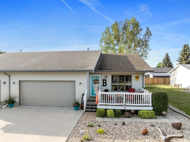 1419 17 1/2 Ave, Minot, ND 58701 - view of front facade featuring an attached garage, covered porch, fence, concrete driveway, and a front lawn