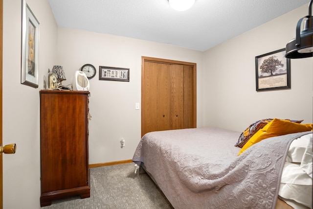 1419 17 1/2 Ave, Minot, ND 58701 - carpeted bedroom featuring a closet and baseboards