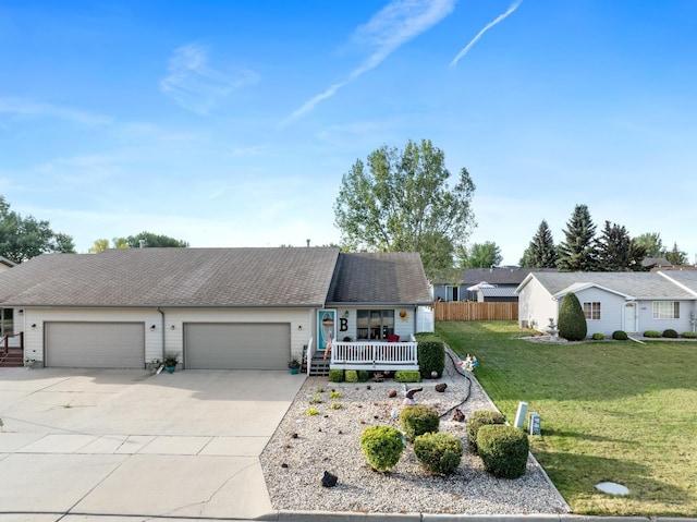 1419 17 1/2 Ave, Minot, ND 58701 - ranch-style house with a porch, fence, a front lawn, an attached garage, and driveway