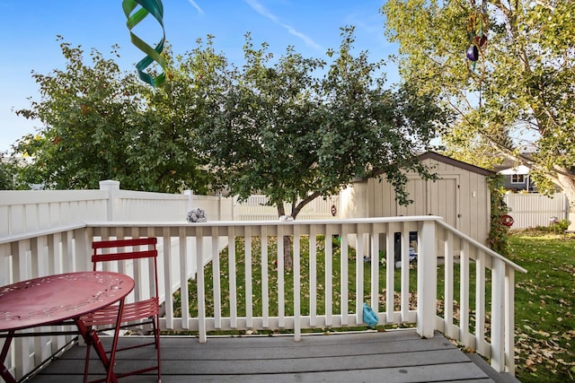 1419 17 1/2 Ave, Minot, ND 58701 - wooden deck featuring a storage shed, a fenced backyard, and an outdoor structure