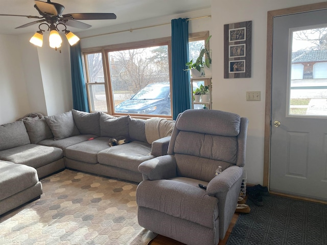 living area with a wealth of natural light and a ceiling fan