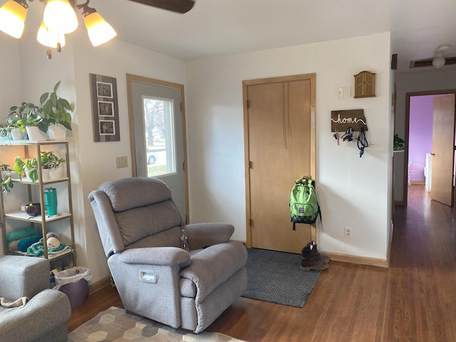 sitting room featuring ceiling fan, baseboards, and wood finished floors