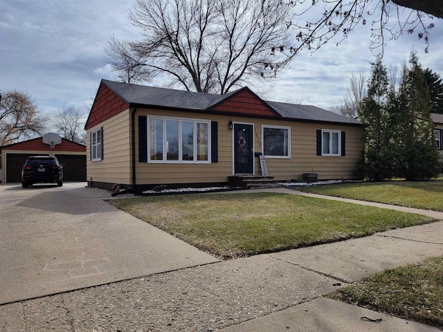 1425 9th St, Minot, ND 58701 - view of front facade with an outbuilding, a detached garage, and a front yard