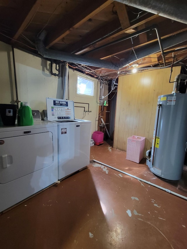 1425 9th St, Minot, ND 58701 - basement featuring washing machine and clothes dryer, wood walls, and gas water heater