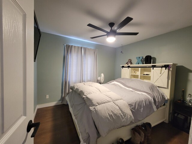 1425 9th St, Minot, ND 58701 - bedroom with baseboards, a ceiling fan, and dark wood-style floors