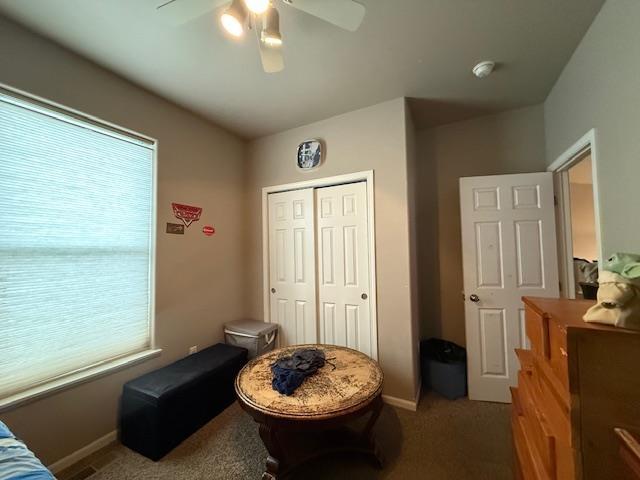 38 Mulberry Loop, Minot, ND 58703 - bedroom with a closet, carpet flooring, baseboards, and ceiling fan