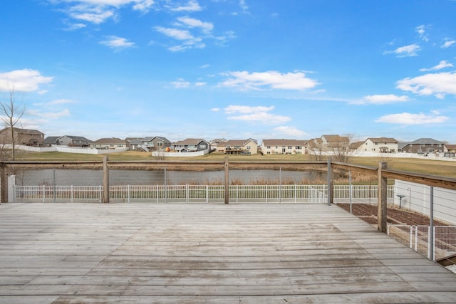 2617 18th St, Minot, ND 58703 - wooden terrace with a fenced backyard, a residential view, and a water view