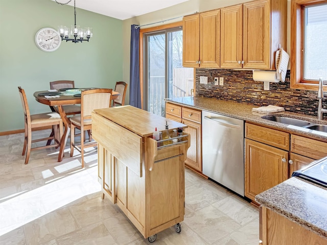 812 15 1/2 Ave SE, Minot, ND 58701 - kitchen with light stone counters, a sink, decorative backsplash, dishwasher, and an inviting chandelier