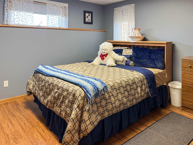 812 15 1/2 Ave SE, Minot, ND 58701 - bedroom with wood finished floors and baseboards