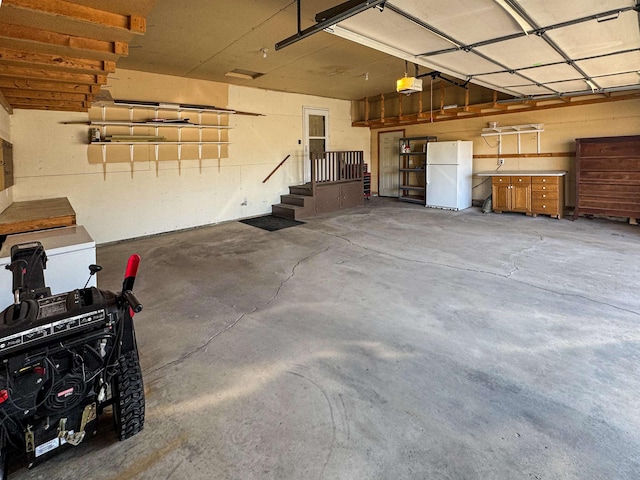 812 15 1/2 Ave SE, Minot, ND 58701 - garage featuring a garage door opener and freestanding refrigerator